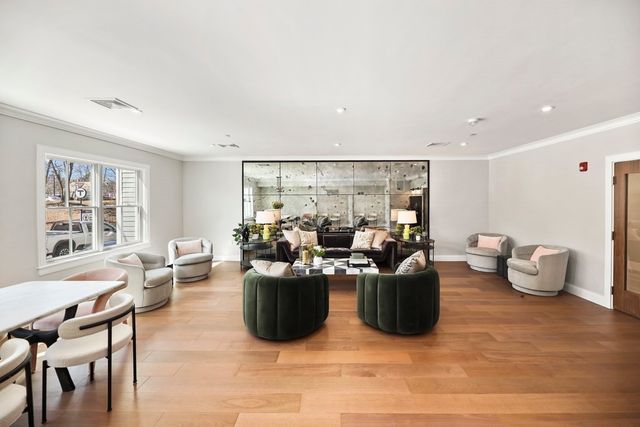 a living room with furniture a window and a table