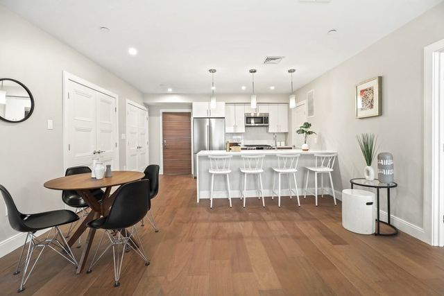 a kitchen with stainless steel appliances kitchen island granite countertop a sink and cabinets