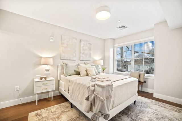 a bedroom with a bed and a large window