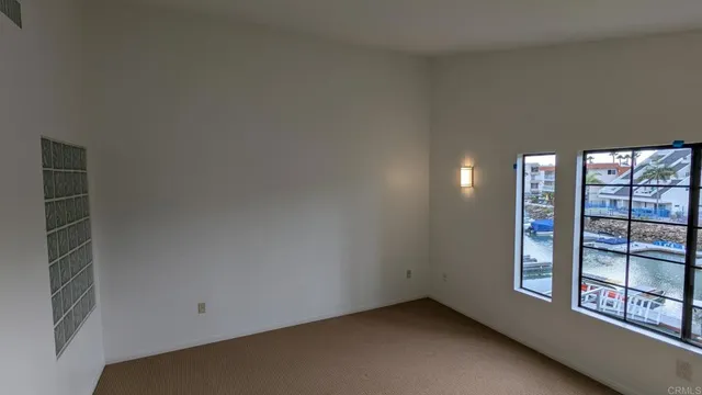 a view of a hallway with a chandelier fan