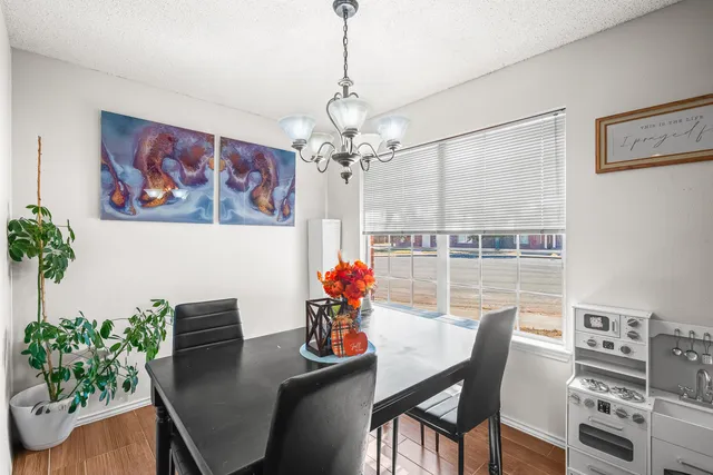 a dining room with furniture and wooden floor