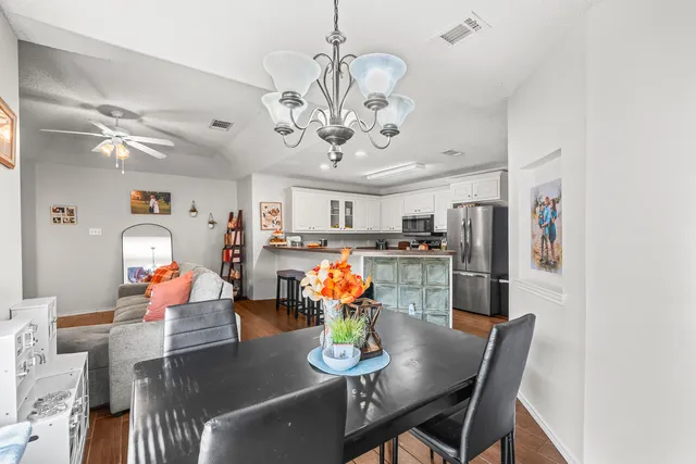 a view of a dining room with furniture and chandelier