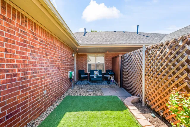a view of a backyard with sitting area