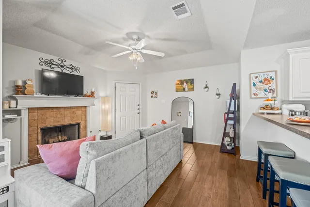 a living room with furniture and a fireplace