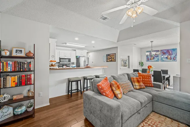 a living room with furniture and a book shelf