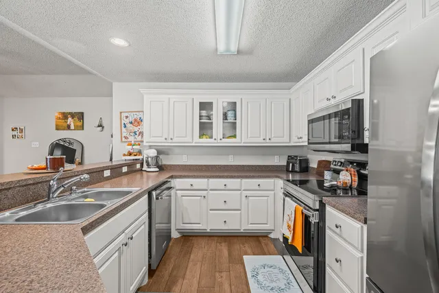 a kitchen with a sink stove and cabinets