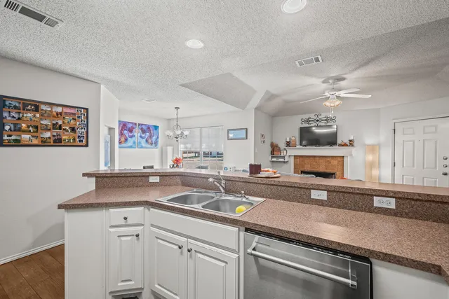 a kitchen with a sink stove and cabinets