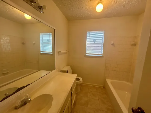 a bath tub sitting next to a toilet