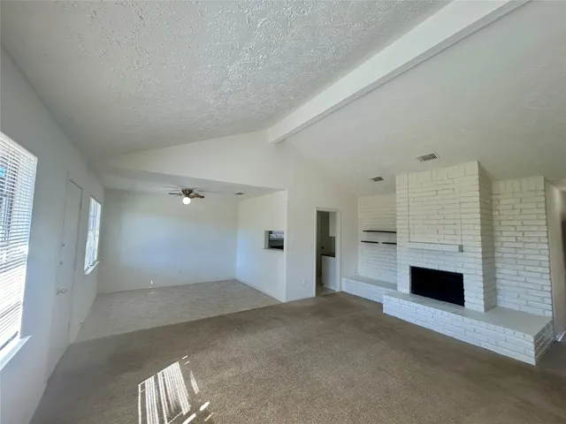 an empty room with a fireplace