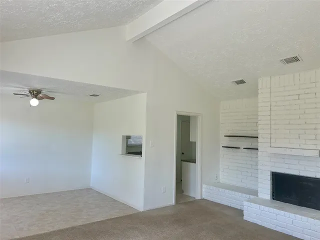 a view of empty room with a fireplace