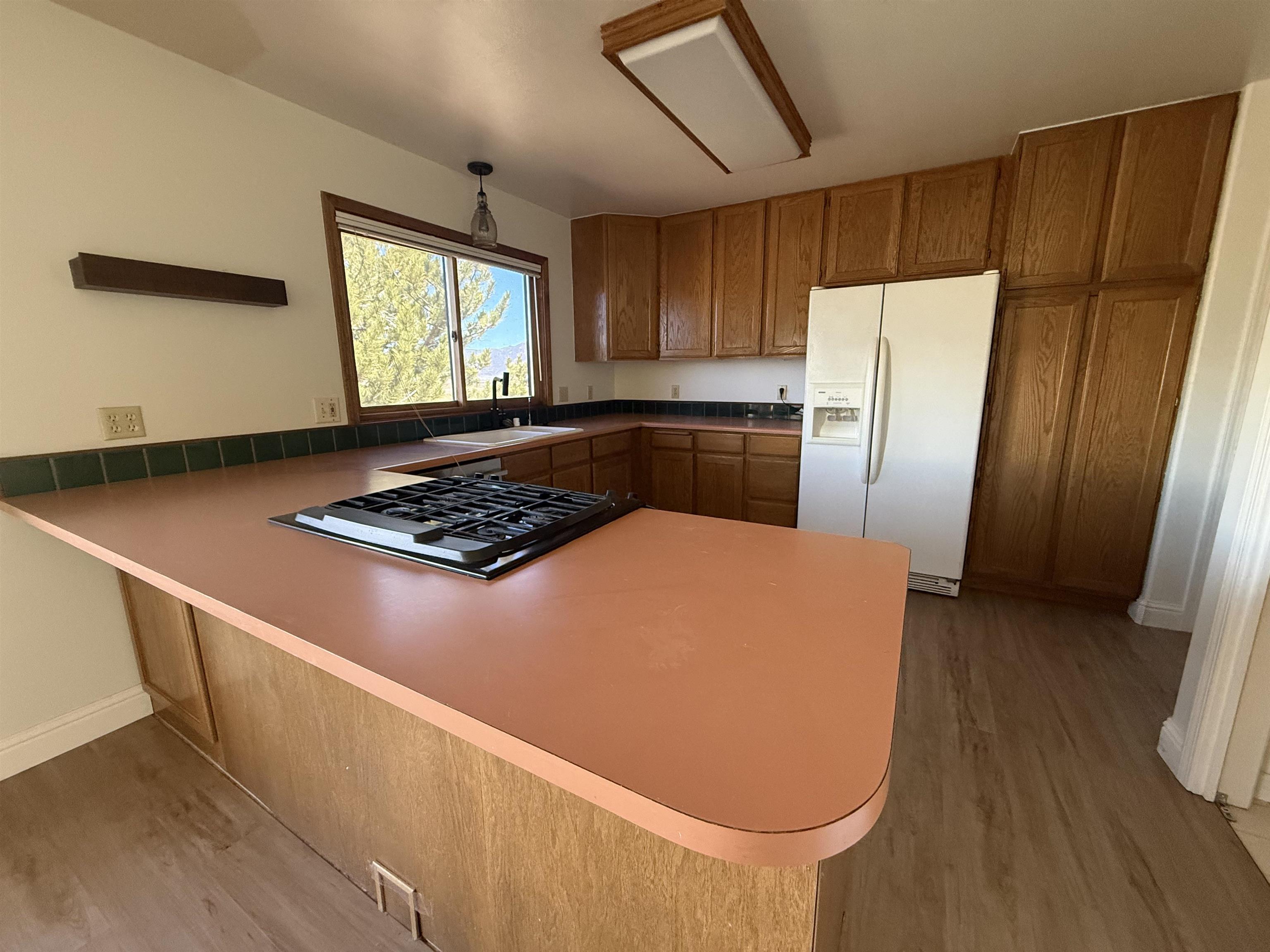 35 Potato Peak Road Bridgeport, CA 93517 - Photo 13 of 21 a kitchen with stainless steel appliances granite countertop a refrigerator a stove and a sink