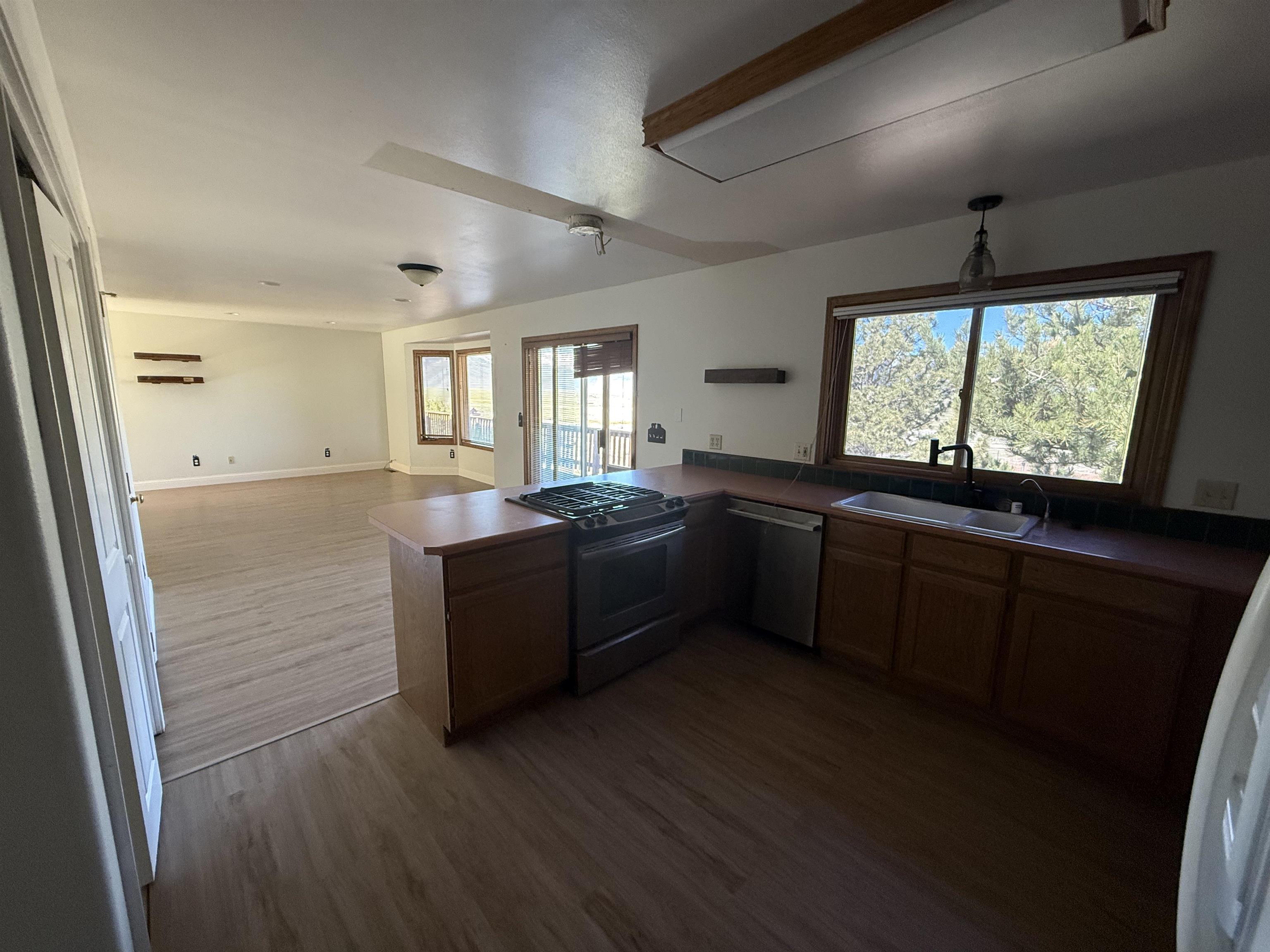 35 Potato Peak Road Bridgeport, CA 93517 - Photo 14 of 21 a kitchen with granite countertop a stove a sink a window and wooden floor