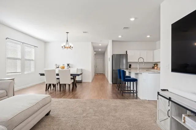 a view of a dining room with furniture and chandelier