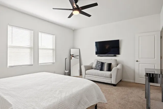 a bedroom with bed and a flat screen tv