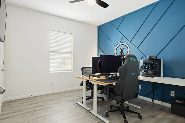 a view of a workspace with furniture and a window