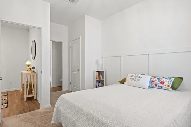 a bedroom with a bed and a table