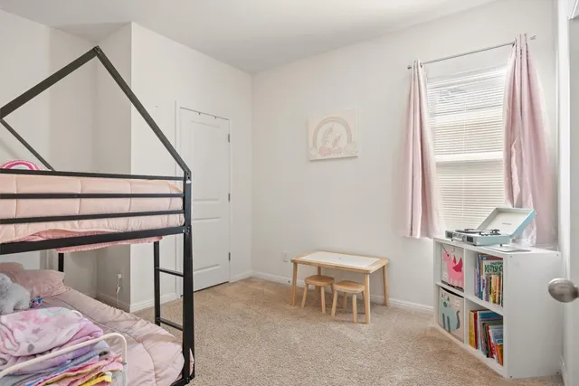 a bedroom with a bed and a bookshelf