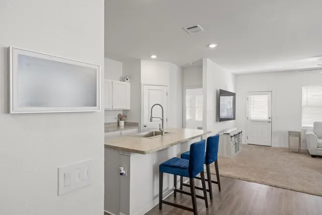 a view of a kitchen with a dining table and chairs