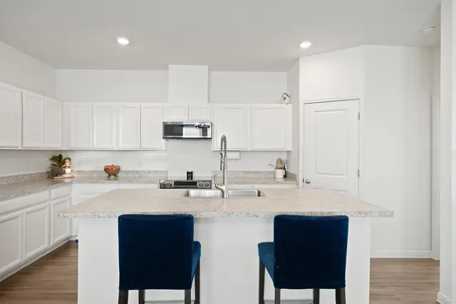 a kitchen with a sink cabinets and window