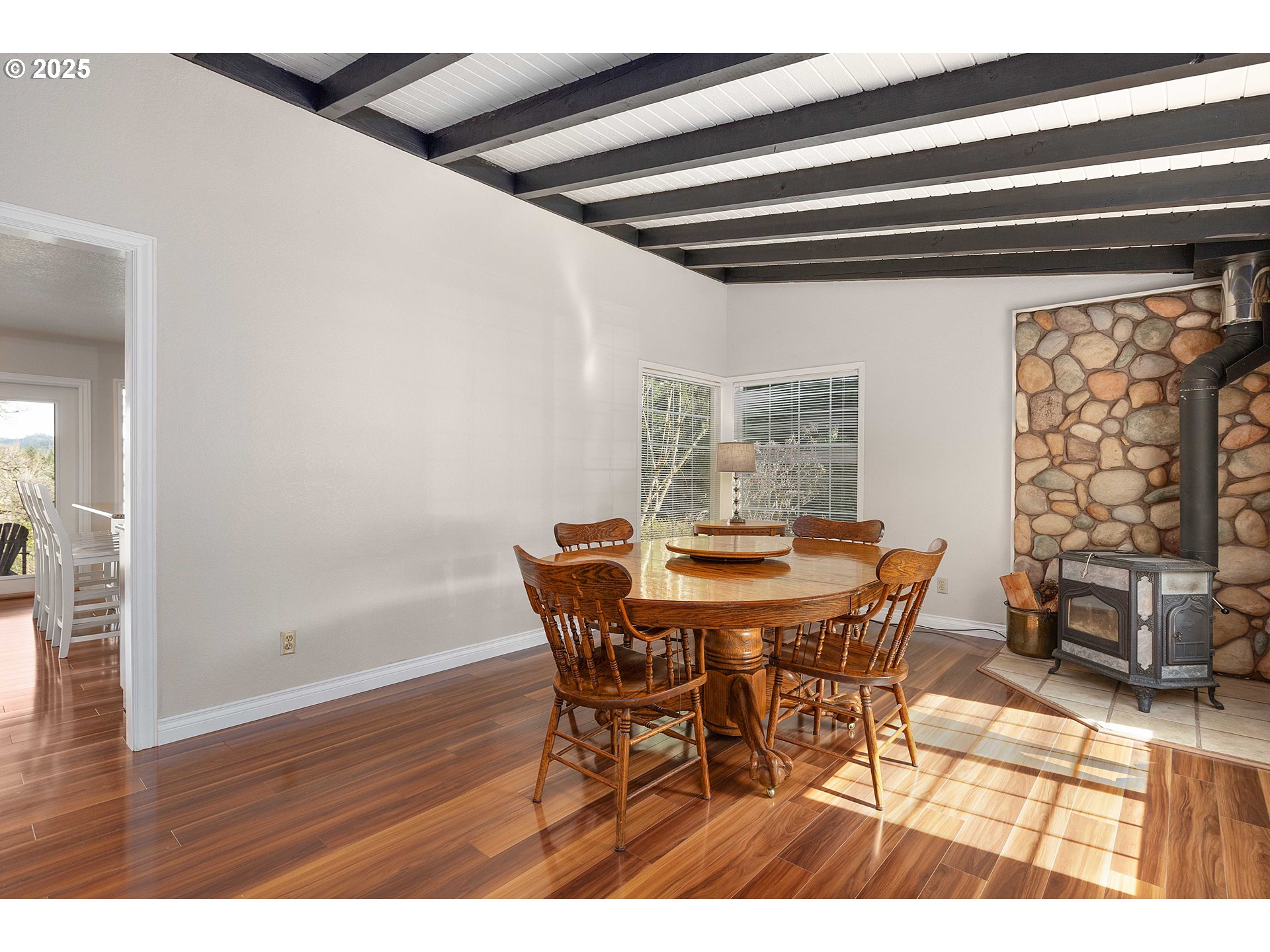 3993 Melqua Road Roseburg, OR 97471 - Photo 16 of 48 a view of a dining room with furniture and wooden floor
