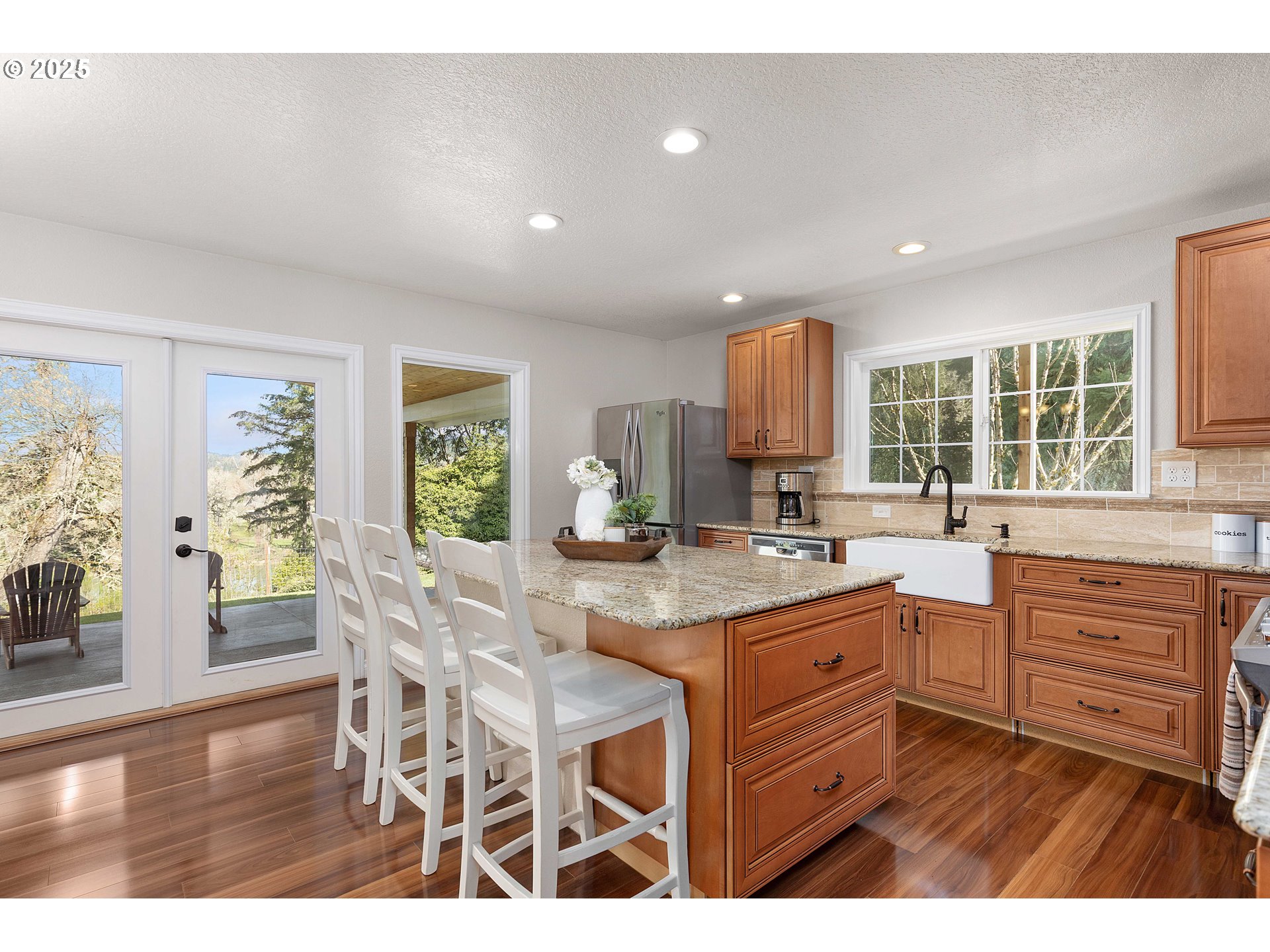 3993 Melqua Road Roseburg, OR 97471 - Photo 19 of 48 a kitchen with granite countertop a table chairs stove and cabinets