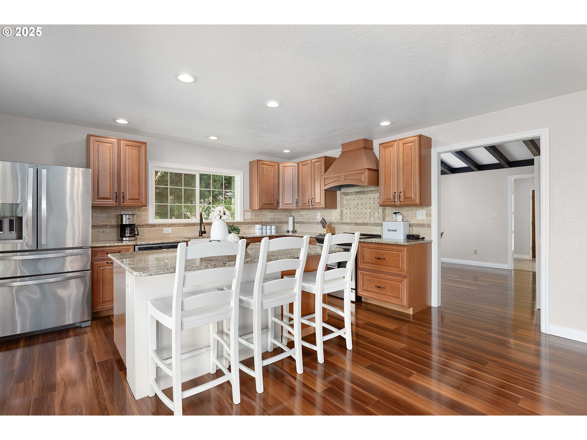 3993 Melqua Road Roseburg, OR 97471 - Photo 20 of 48 a kitchen with stainless steel appliances kitchen island granite countertop a refrigerator and a stove top oven