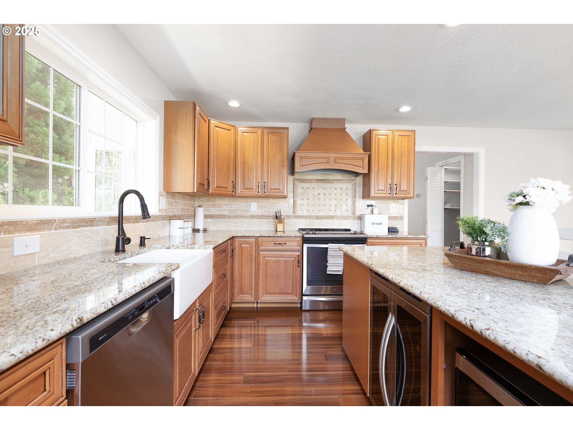 3993 Melqua Road Roseburg, OR 97471 - Photo 22 of 48 a kitchen with stainless steel appliances granite countertop a sink a stove and a wooden cabinets