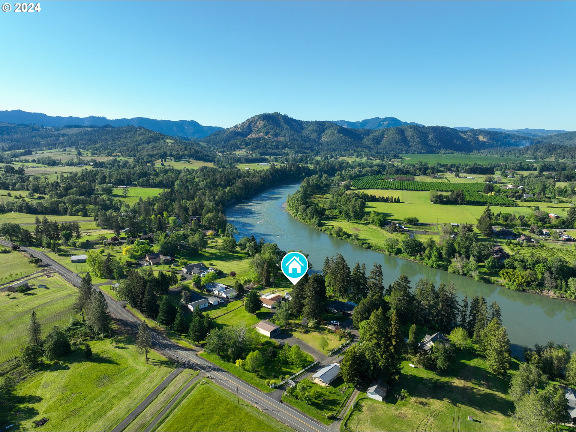 3993 Melqua Road Roseburg, OR 97471 - Photo 3 of 48 a view of a lush green field with mountains in the background