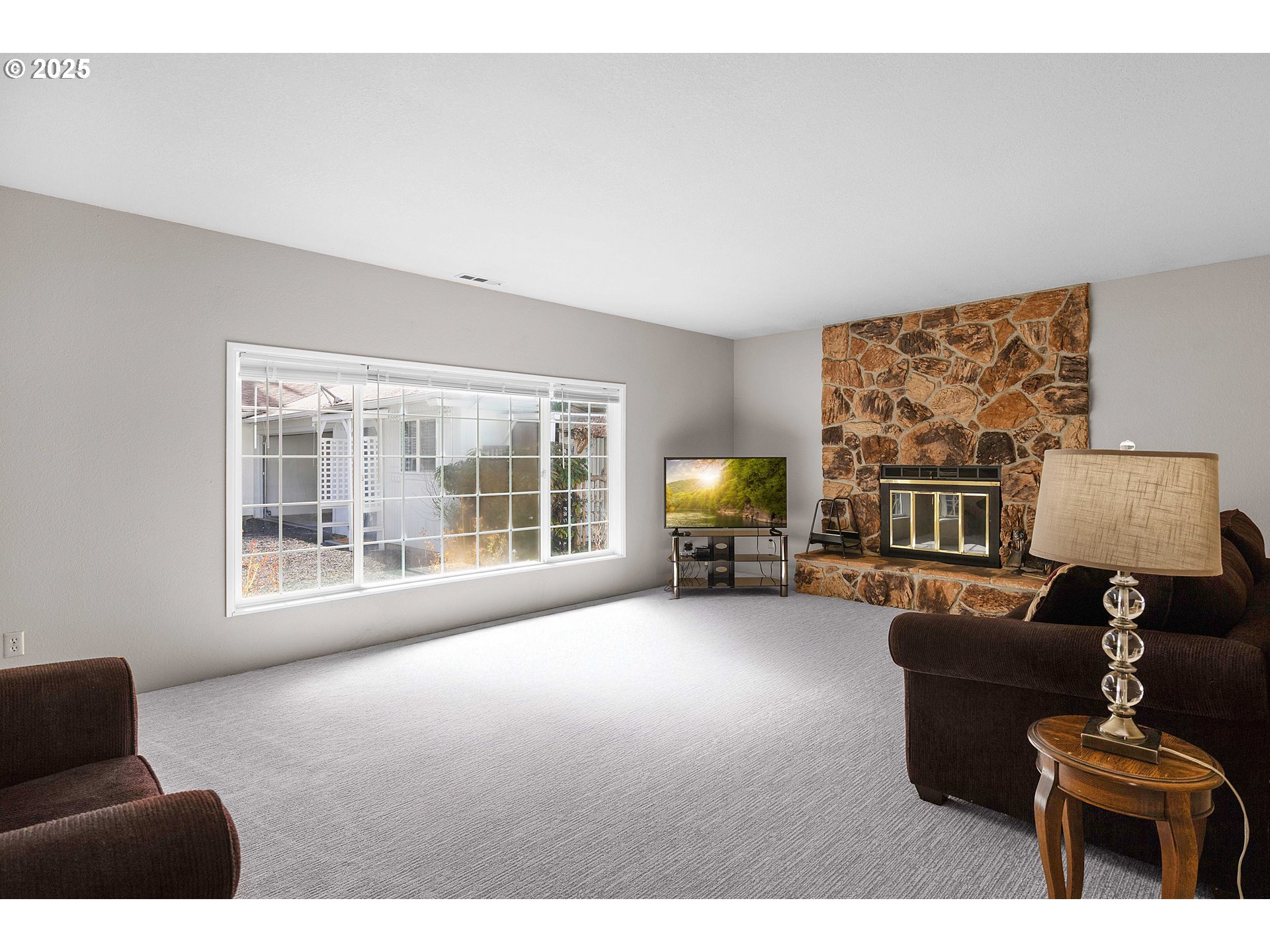 3993 Melqua Road Roseburg, OR 97471 - Photo 36 of 48 a living room with furniture a fireplace and a flat screen tv