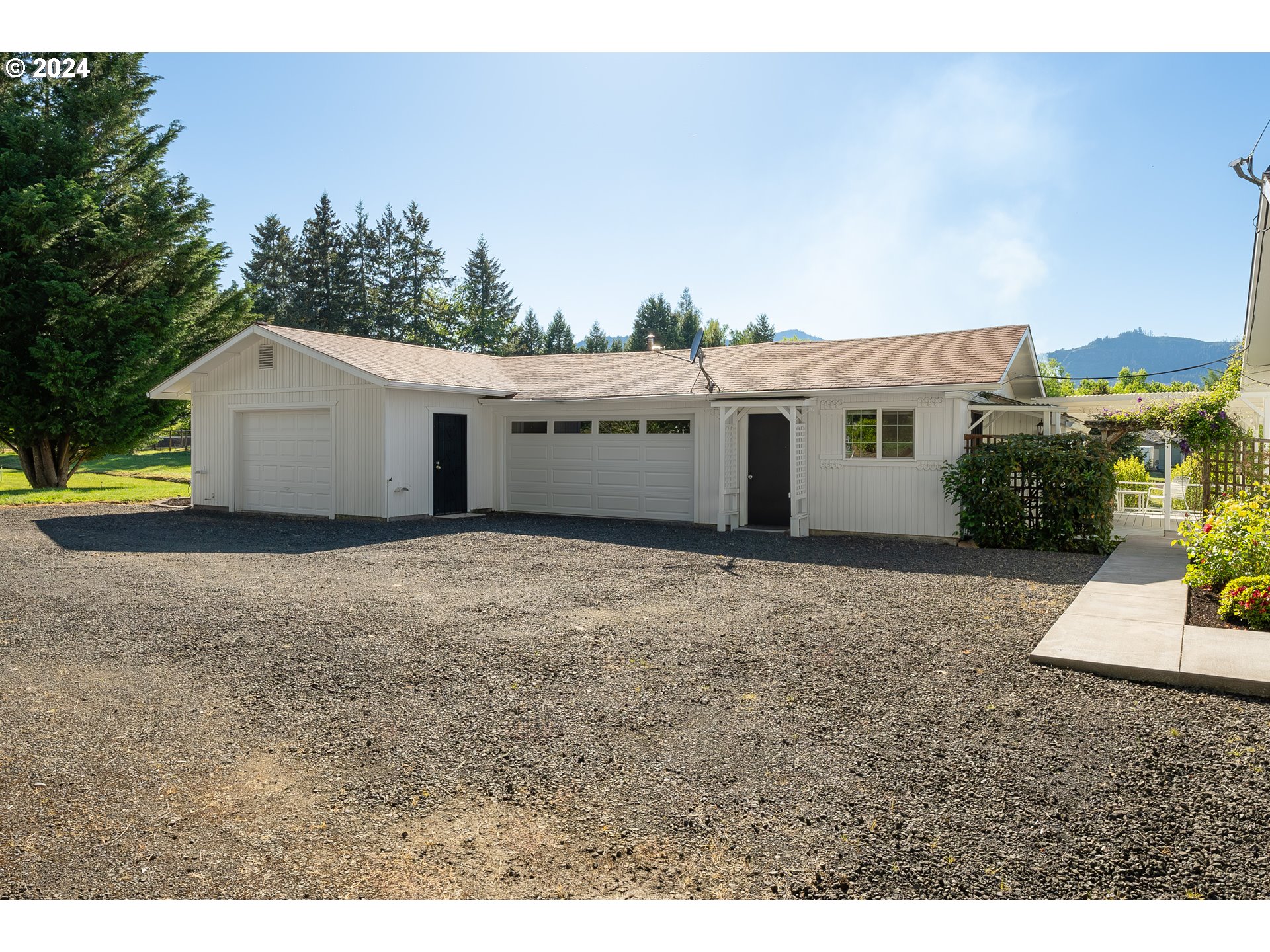 3993 Melqua Road Roseburg, OR 97471 - Photo 44 of 48 a view of an house with backyard and bushes