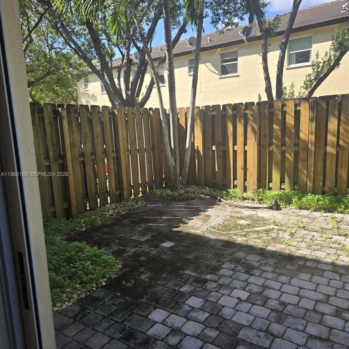 9031 Southwest 227th Street, Unit 5 Cutler Bay, FL 33190 - Photo 11 of 21 a view of a backyard of the house