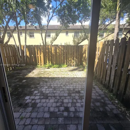 a view of yard with tree in front of it