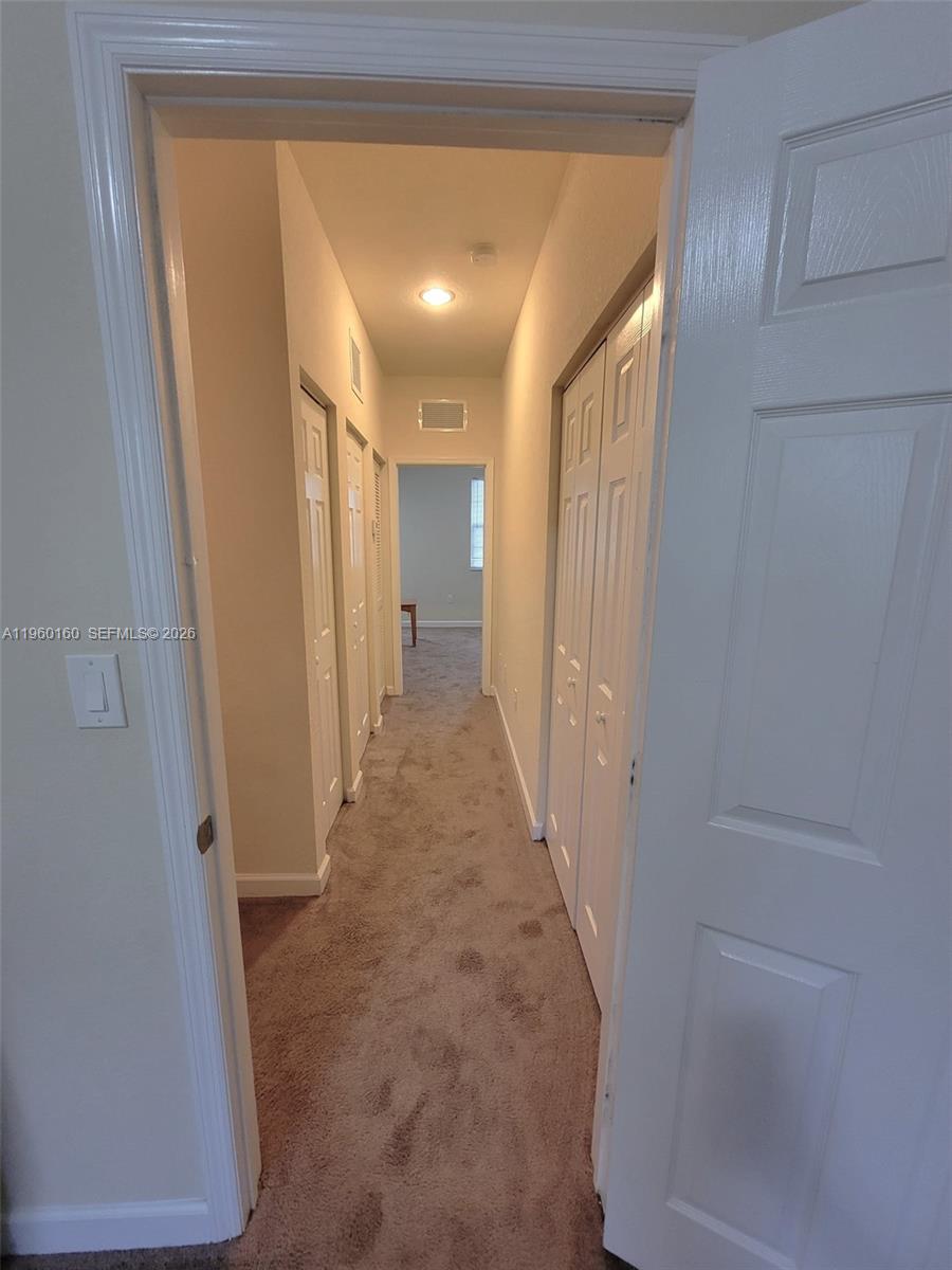 9031 Southwest 227th Street, Unit 5 Cutler Bay, FL 33190 - Photo 14 of 21 a view of a hallway