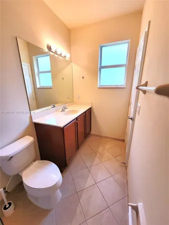 a bathroom with a sink a toilet a mirror and vanity