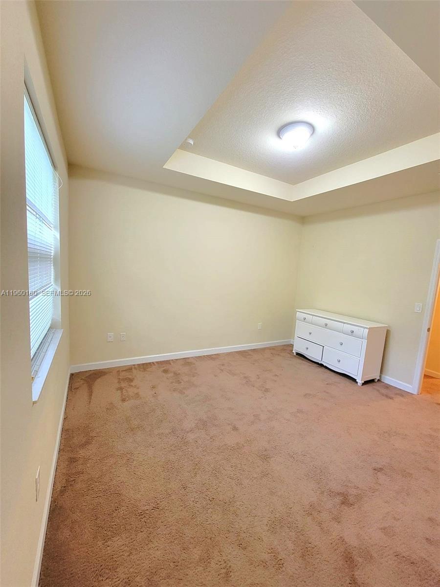 9031 Southwest 227th Street, Unit 5 Cutler Bay, FL 33190 - Photo 19 of 21 a view of a room with an empty space and a window