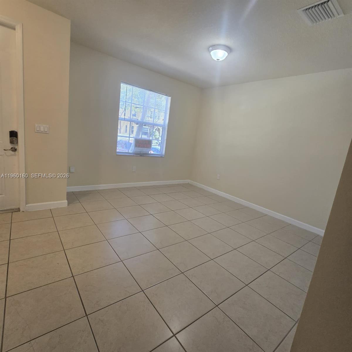 9031 Southwest 227th Street, Unit 5 Cutler Bay, FL 33190 - Photo 2 of 21 an empty room with windows