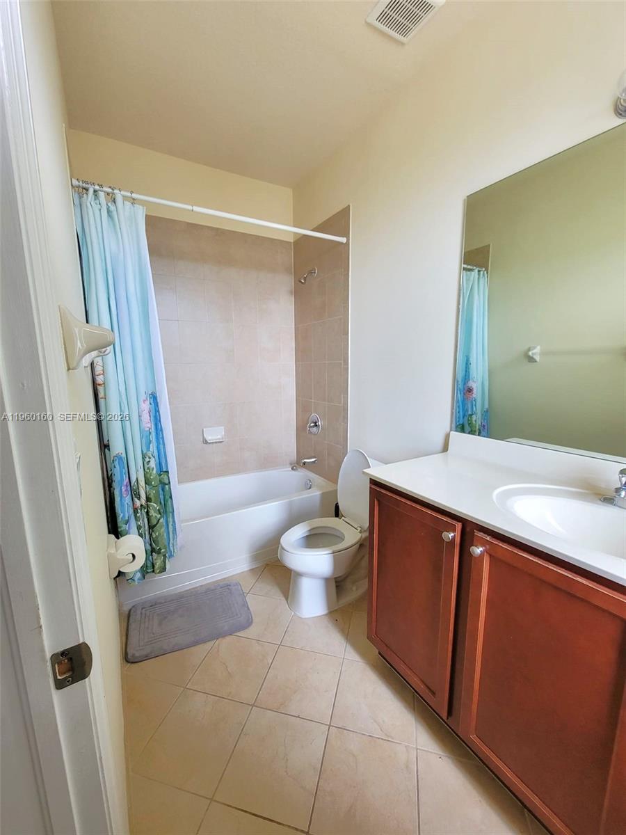 9031 Southwest 227th Street, Unit 5 Cutler Bay, FL 33190 - Photo 21 of 21 a bathroom with a sink a toilet and a shower