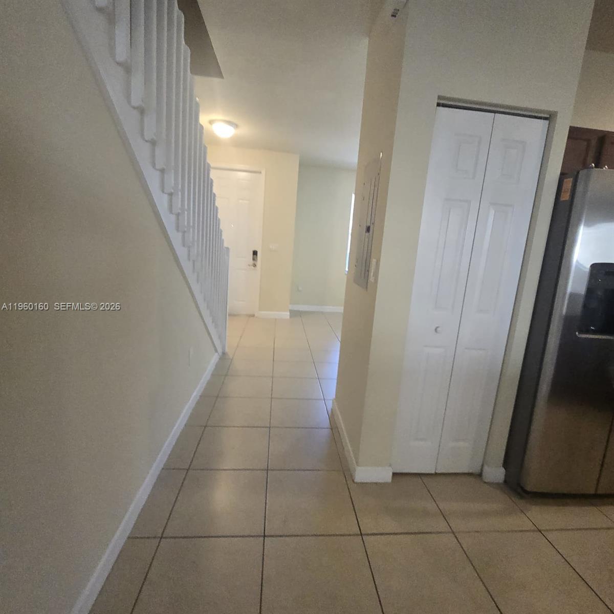 9031 Southwest 227th Street, Unit 5 Cutler Bay, FL 33190 - Photo 4 of 21 a view of hallway with stairs and a window