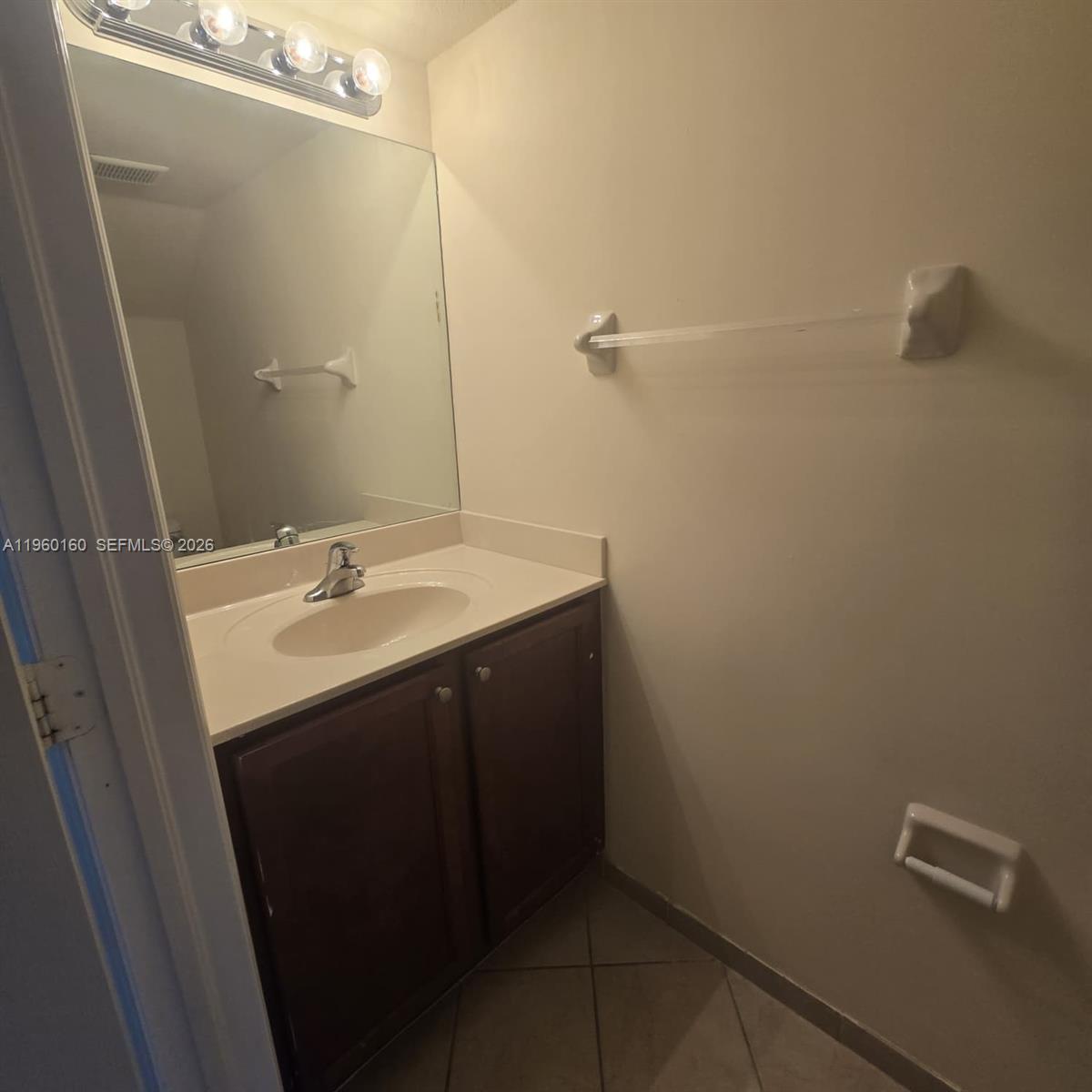 9031 Southwest 227th Street, Unit 5 Cutler Bay, FL 33190 - Photo 6 of 21 a bathroom with a sink and mirror