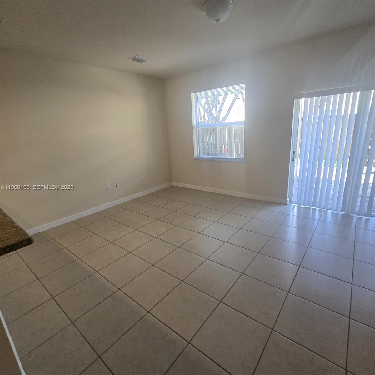 9031 Southwest 227th Street, Unit 5 Cutler Bay, FL 33190 - Photo 10 of 21 an empty room with windows
