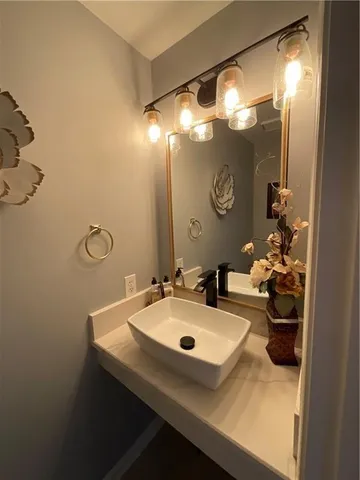 a bathroom with a sink mirror and vanity