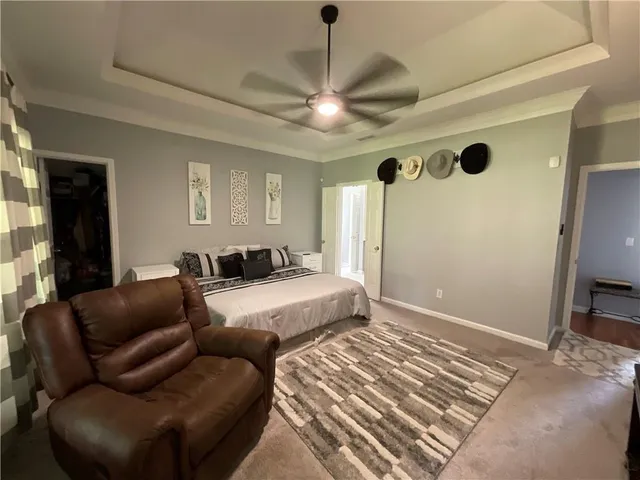 a bedroom with furniture and a flat screen tv