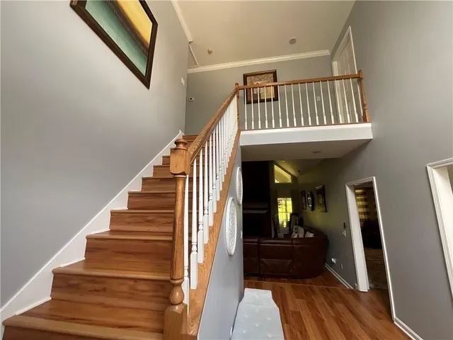 a view of entryway and hall with wooden floor