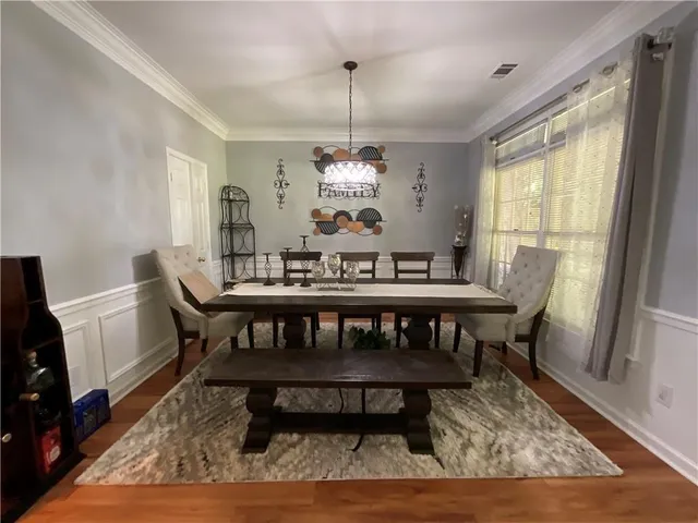 a view of a dining room with furniture window and wooden floor
