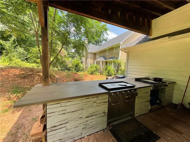 a kitchen with stainless steel appliances granite countertop a stove and a wooden floor
