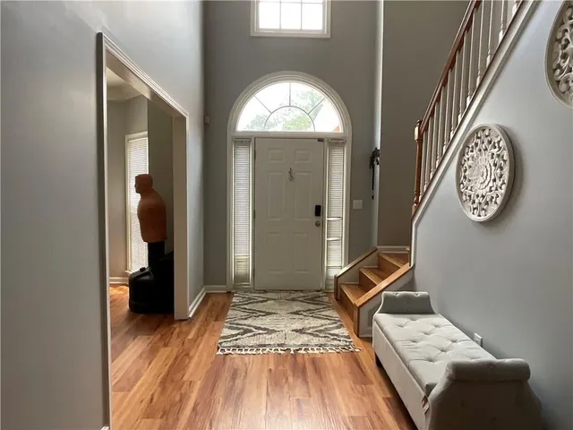 a view of a livingroom with wooden floor and a bed