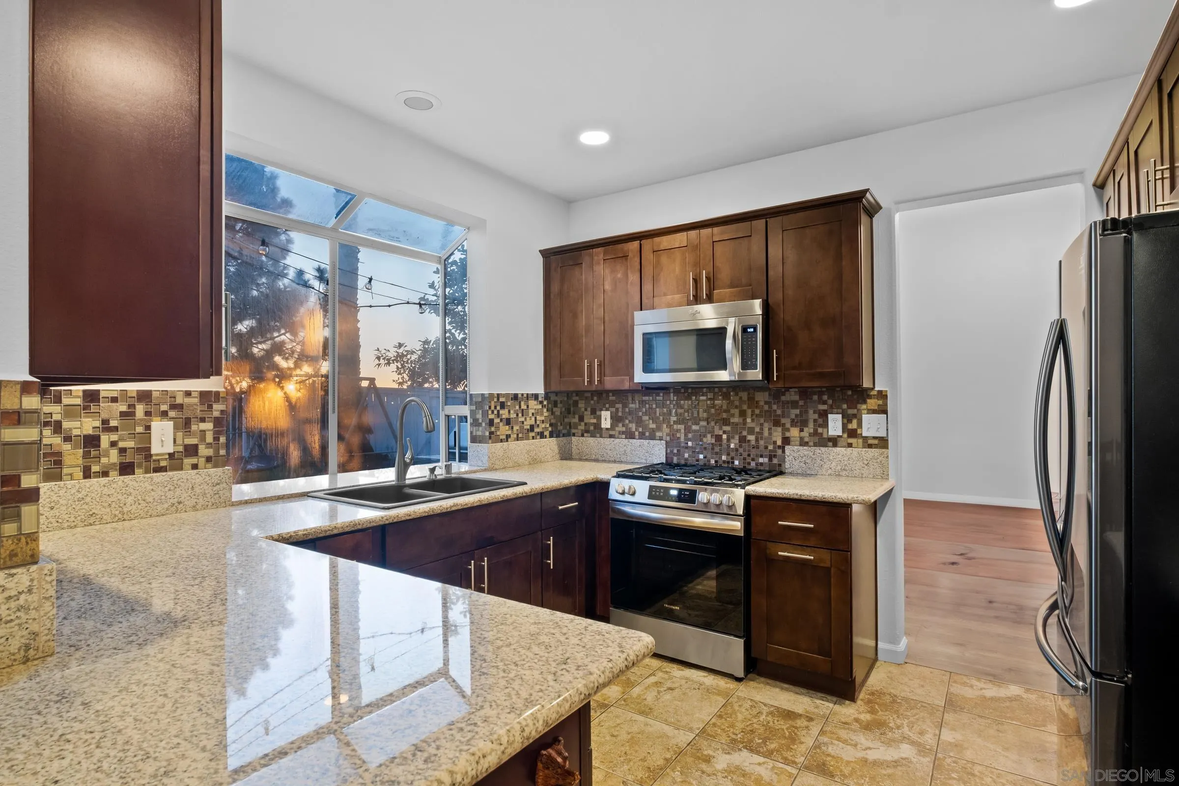 536 Kiley Road Chula Vista, CA 91910 - Photo 16 of 46 a kitchen with stainless steel appliances granite countertop a sink stove and refrigerator