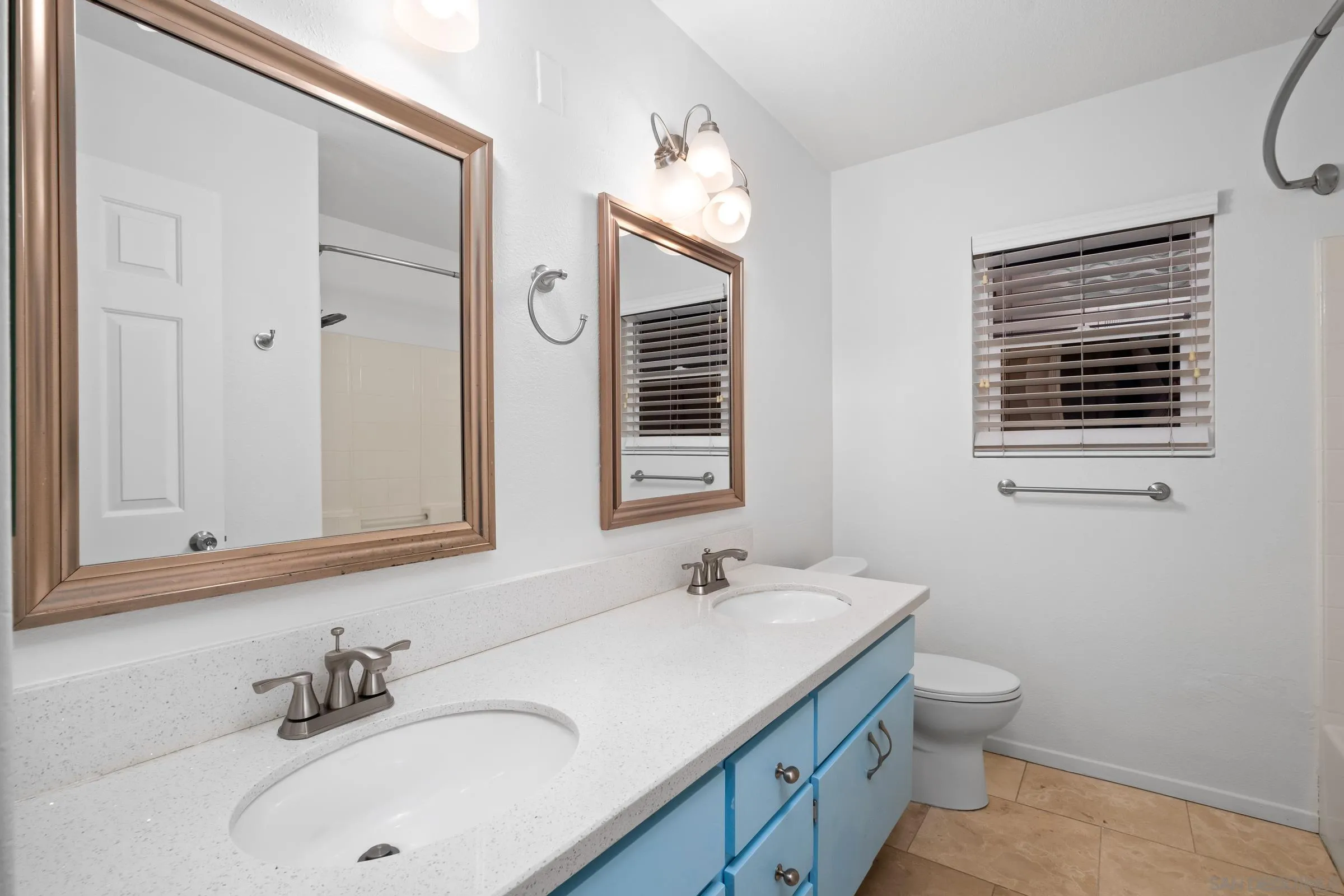536 Kiley Road Chula Vista, CA 91910 - Photo 27 of 46 a bathroom with a sink a toilet and a mirror