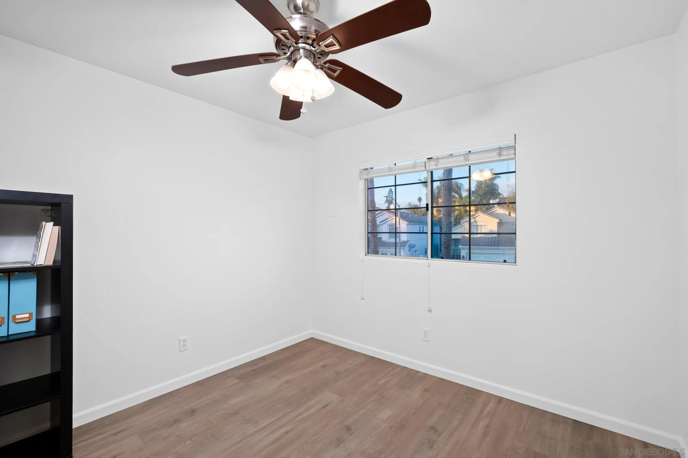 536 Kiley Road Chula Vista, CA 91910 - Photo 28 of 46 an empty room with wooden floor and chandelier fan