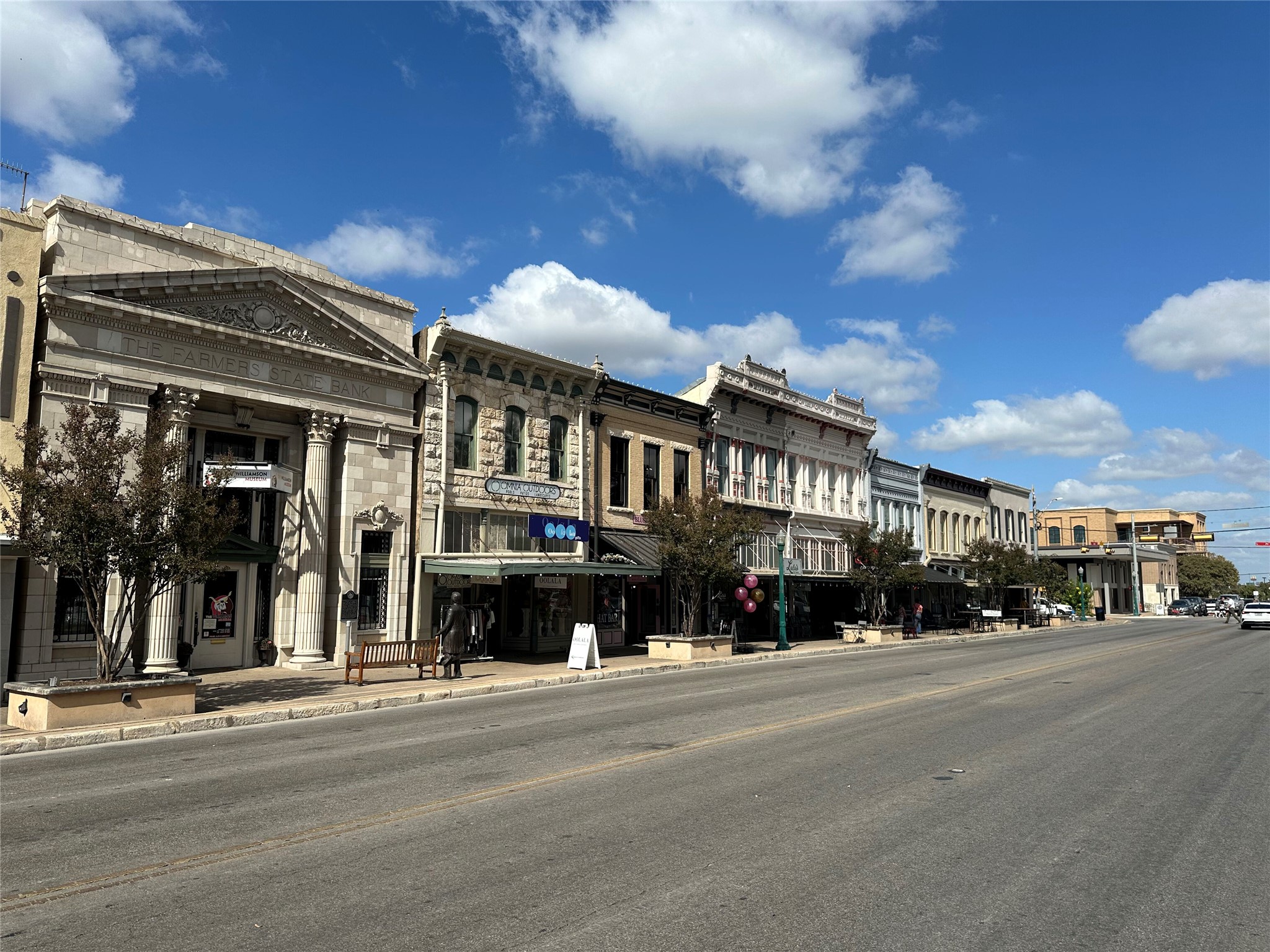 506 Central Drive Georgetown, TX 78628 - Photo 28 of 29 a city street lined with buildings and a cars parked on the side of road